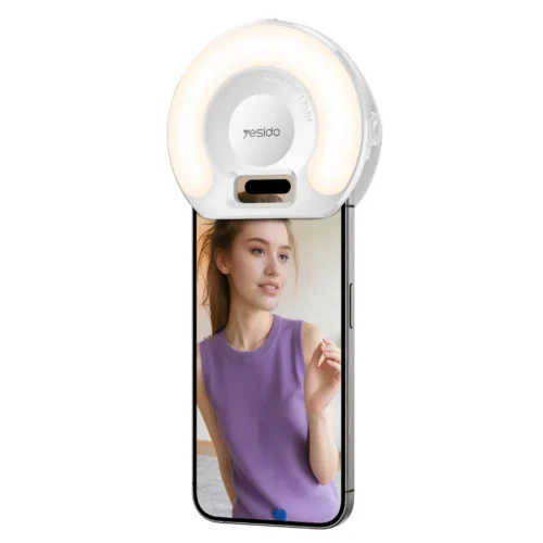 Aro de luz para celular Yesido DH13 Aro de luz para celular Yesido DH13 con clip puesto sobre un smartphone, luz cálida encendida